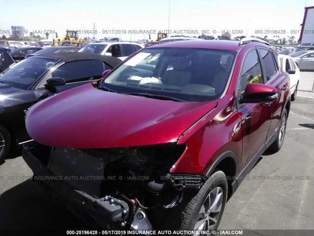 JTMRJREV2JD186812 - 2018 TOYOTA RAV4 HV LE PLUS/XLE BURGUNDY photo 2